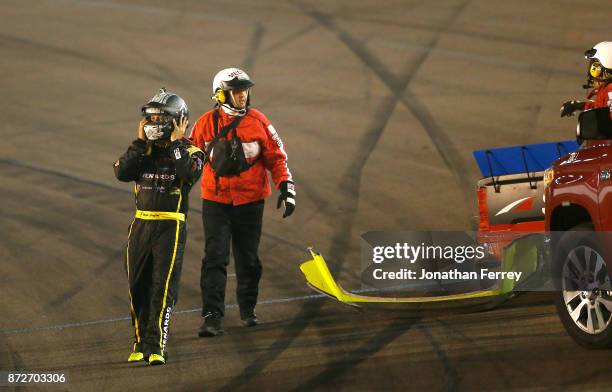 Matt Crafton, driver of the Ideal Door/Menards Toyota, walks to the ambulance after crashing during the NASCAR Camping World Truck Series Lucas Oil...