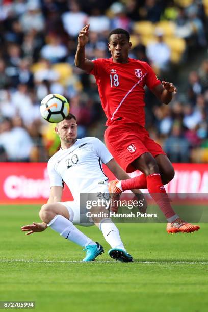 Tommy Smith of the All Whites kicks the ball past Andre Carrillo of Peru during the 2018 FIFA World Cup Qualifier match between the New Zealand All...