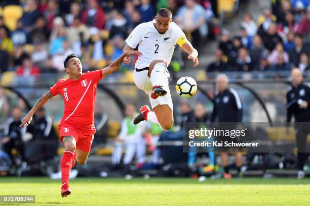 Winston Reid of the All Whites controls the ball from Christian Cueva of Peru during the 2018 FIFA World Cup Qualifier match between the New Zealand...