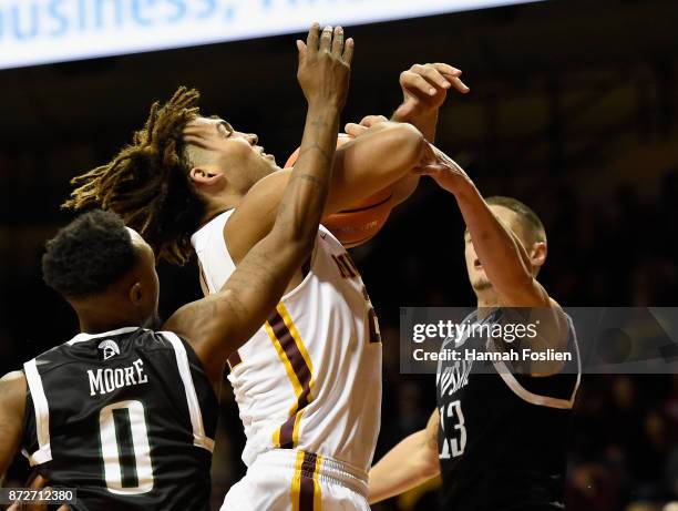 Reggie Lynch of the Minnesota Golden Gophers attempts to shoots the ball against Malik Moore and Carson Smith of the USC Upstate Spartans during the...