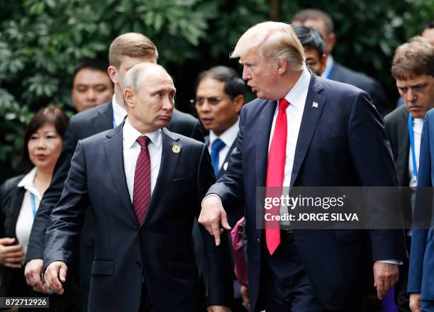 President Donald Trump and Russia's President Vladimir Putin talk as they make their way to take the "family photo" during the Asia-Pacific Economic...