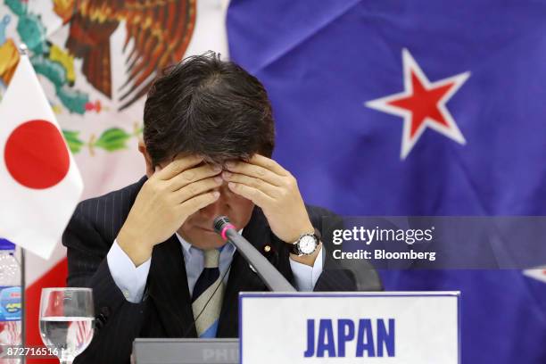 Toshimitsu Motegi, Japan's minister of economy, reacts during a news conference with Tran Tuan Anh, Vietnam's minister of industry and trade, not...