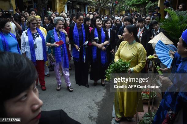Spouses of APEC leaders enjoy a sightseeing tour in the central Vietnamese town of Hoi An on November 11 as leaders meet in nearby Danang for the...