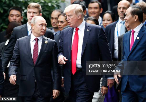 President Donald Trump and Russia's President Vladimir Putin talk as they make their way to take the "family photo" during the Asia-Pacific Economic...