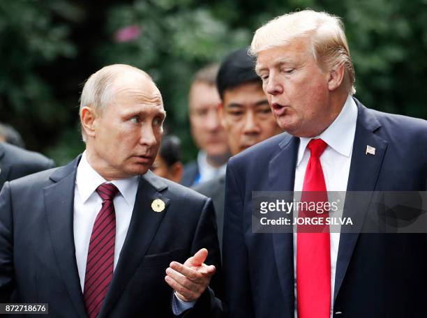 President Donald Trump and Russia's President Vladimir Putin talk as they make their way to take the "family photo" during the Asia-Pacific Economic...