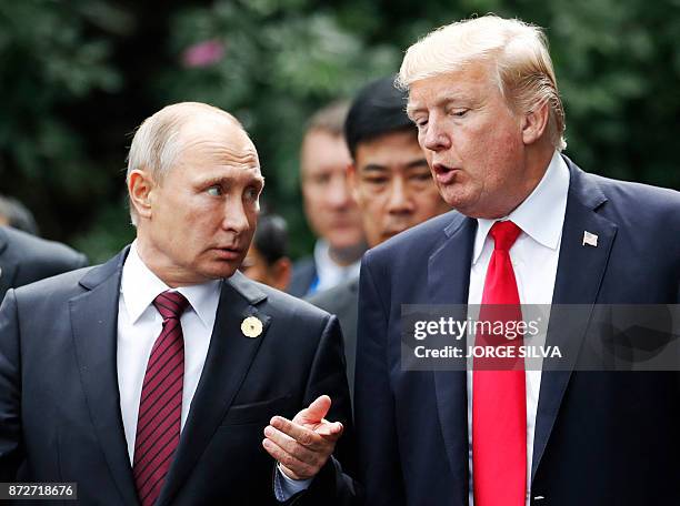 President Donald Trump and Russia's President Vladimir Putin talk as they make their way to take the "family photo" during the Asia-Pacific Economic...