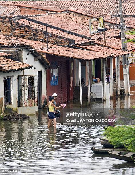 Couple leaves its house, flooded by the Mearim river in Bacabal, in the state of Maranhao, northern Brazil, on May 15, 2009. Around a million people...