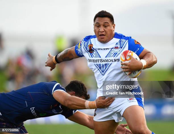 Josh Papalii of Samoa is tackled during the 2017 Rugby League World Cup match between Samoa and Scotland at Barlow Park on November 11, 2017 in...