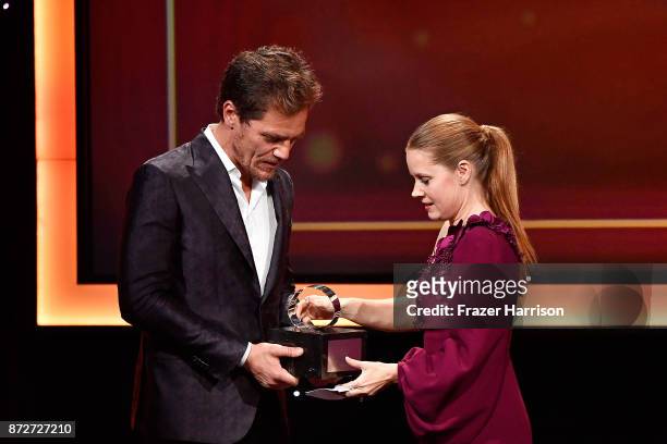 Honoree Amy Adams accepts the American Cinematheque Award from Michael Shannon onstage during the 31st Annual American Cinematheque Awards Gala at...