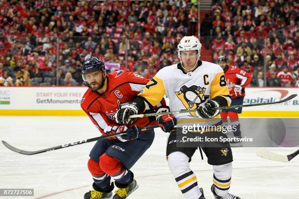 Washington Capitals left wing Alex Ovechkin and Pittsburgh Penguins center Sidney Crosby fight for a second period puck on November 10 at the Capital...