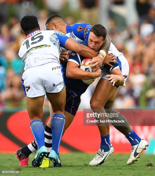 Brandon Wilkinson of Scotland is tackled by Joseph Paulo of Samoa during the 2017 Rugby League World Cup match between Samoa and Scotland at Barlow...