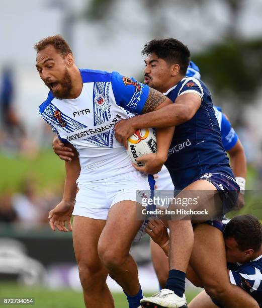 Sam Tagataese of Samoa is tackled during the 2017 Rugby League World Cup match between Samoa and Scotland at Barlow Park on November 11, 2017 in...