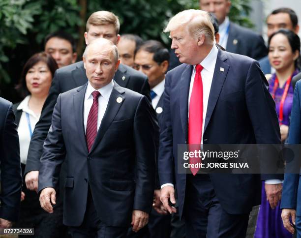 President Donald Trump and Russia's President Vladimir Putin talk as the make their way to take the "family photo" during the Asia-Pacific Economic...