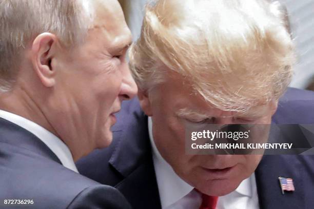 Russia's President Vladimir Putin and US President Donald Trump talk as they attend the Asia-Pacific Economic Cooperation leaders' summit in the...