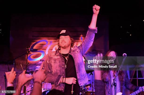 Lead singer and guitarist Michael Hobby and bassist Graham DeLoach of A Thousand Horses perform at Stoney's Rockin' Country on November 10, 2017 in...