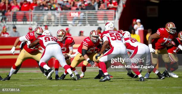 Brandon Fusco, Daniel Kilgore and Trent Brown of the San Francisco 49ers block for C.J. Beathard during the game against the Arizona Cardinals at...