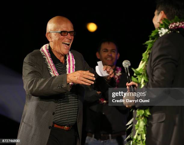 Dr. Peter Weller greets Peter Lenkov as he goes up on stage before the Sunset on the Beach event celebrating season 8 of "Hawaii Five-0" at Queen's...