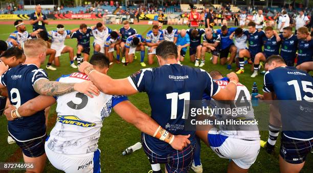 Samoan and Scottish teams gather together for a prayer after the 2017 Rugby League World Cup match between Samoa and Scotland at Barlow Park on...