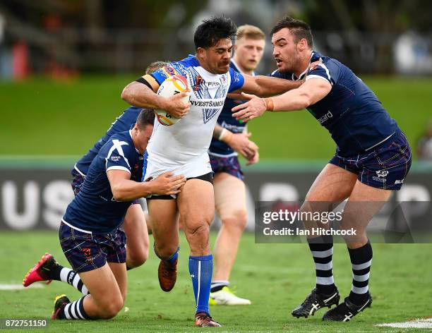 Young Tonumaipea of Samoa is tackled by Luke Douglas of Scotland during the 2017 Rugby League World Cup match between Samoa and Scotland at Barlow...