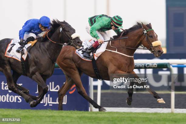 Jockey Jamie Spencer riding Certerach wins the Dubai Gold Cup during the Dubai World Cup race day at the Meydan racecourse on March 29, 2014 in...