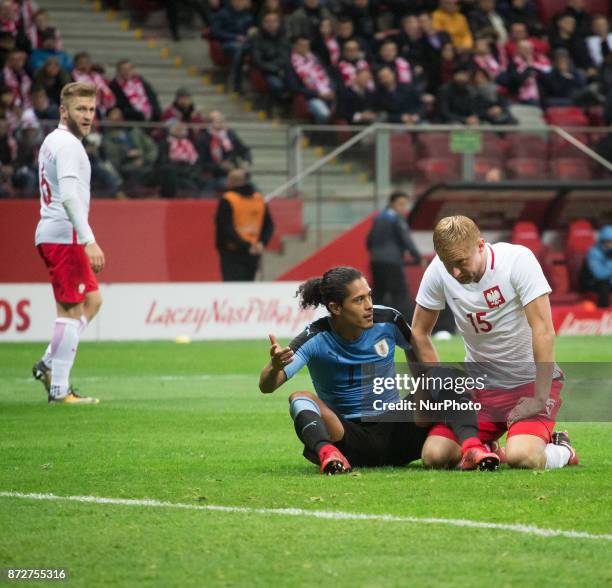 Mauricio Lemos and Kamil Glik during the international friendly soccer match between Poland and Uruguay at the PGE National Stadium in Warsaw, Poland...
