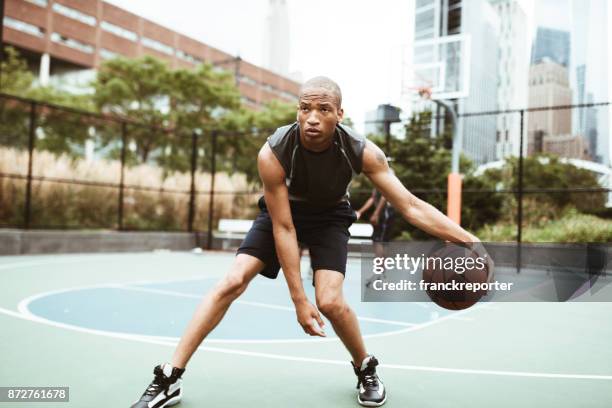 friends playing street basketball in new york city - balls bouncing stock pictures, royalty-free photos & images