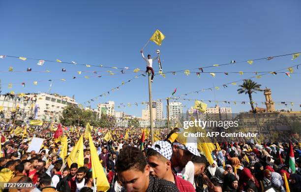 Fatah supporters wave the party flag as they take part in a rally in Gaza City on November 11, 2017. Marking the death anniversary of late...