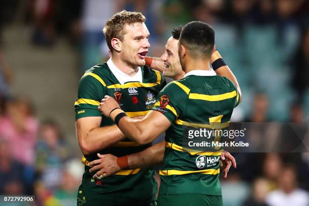 Tom Trbojevic of Australia celebrates with his team mates Cooper Cronk and Valentine Holmes of Australia after scoring a try during the 2017 Rugby...