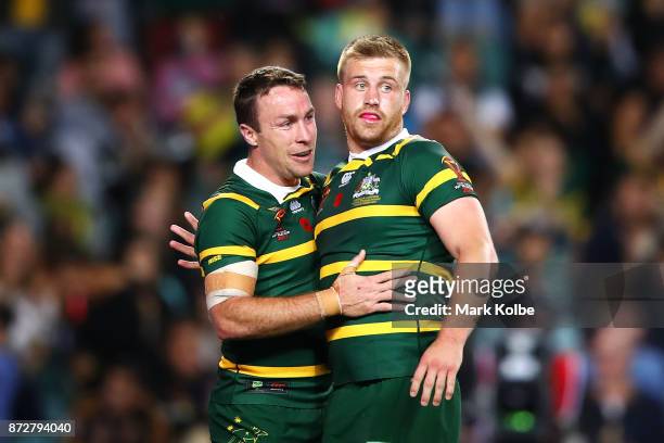 James Maloney and Cameron Munster of Australia celebrate Munster scoring a try during the 2017 Rugby League World Cup match between Australia and...