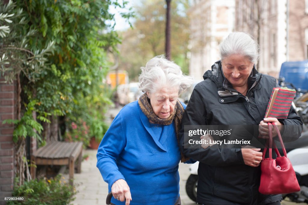 Woman taking a 101-year old woman home