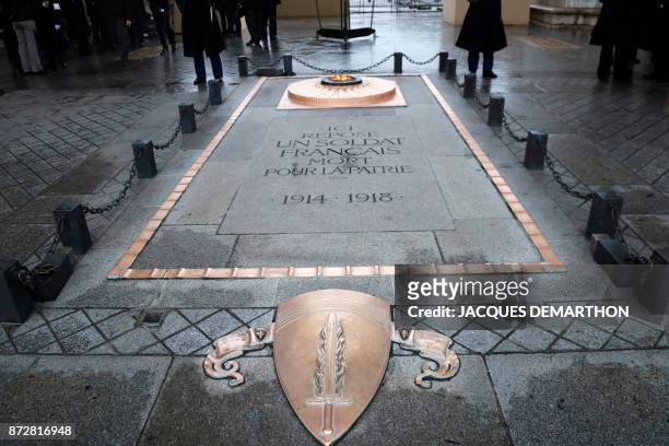 Picture taken on November 11, 2017 shows the eternal flame of the Tomb of the Unknown soldier beneath the Arc de Triomphe, in Paris, during the...