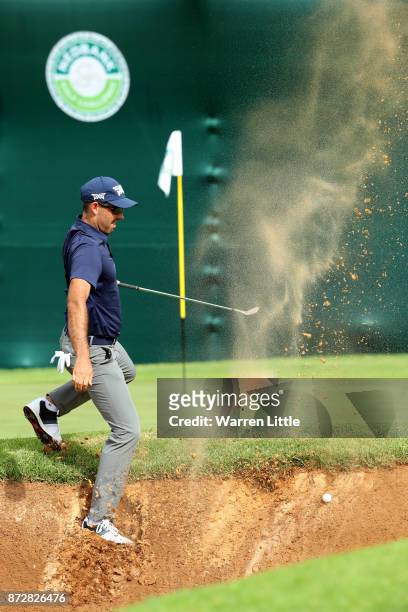 Charl Schwartzel of South Africa hits from a bunker on the 18th hole during the third round of the Nedbank Golf Challenge at Gary Player CC on...