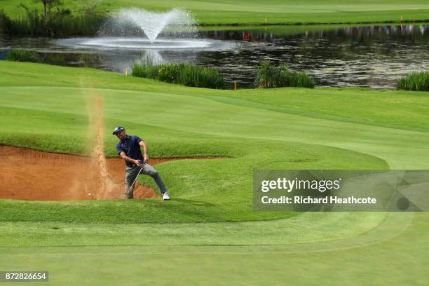 Charl Schwartzel of South Africa hits from a bunker on the 18th hole during the third round of the Nedbank Golf Challenge at Gary Player CC on...