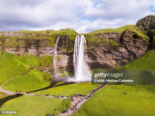 aerial drone view of seljalandsfoss waterfall in iceland - セリャランスフォス ストックフォトと画像