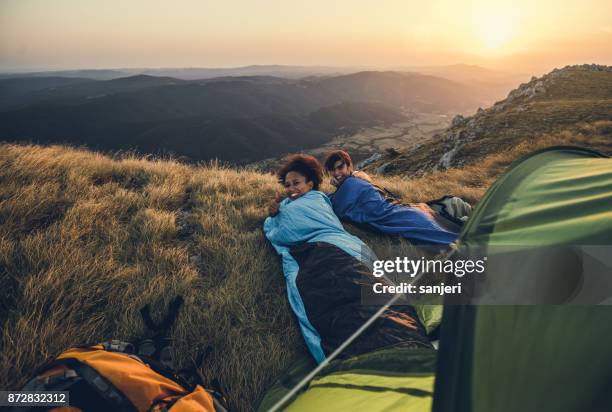 jóvenes excursionistas camping en colina - saco de dormir fotografías e imágenes de stock