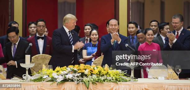 Vietnamese President Tran Dai Quang and US President Donald Trump attend a state dinner in Hanoi on November 11, 2017. Trump arrived in the...