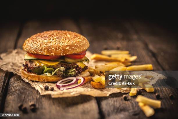 tasty hamburger with french fries on wooden table - chips stock pictures, royalty-free photos & images