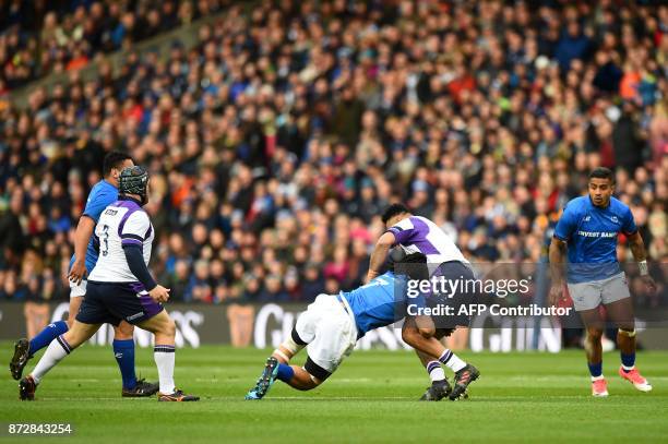 Samoa's flanker TJ Ioane tackles Scotland's prop Darryl Marfo during the autumn international rugby union test match between Scotland and Samoa at...