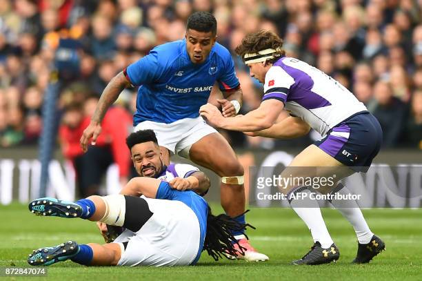 Samoa's flanker TJ Ioane tackles Scotland's prop Darryl Marfo during the autumn international rugby union test match between Scotland and Samoa at...