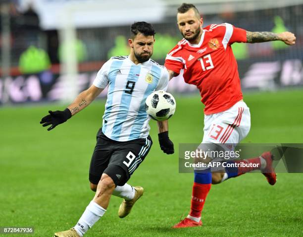 Argentina's Sergio Aguero and Russia's defender Fedor Kudryashov vie for the ball during an international friendly football match between Russia and...