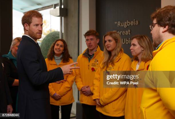 Prince Harry meets with the Commonwealth War Grave Commission volunteers before the Rugby Union International match between England and Argentina at...