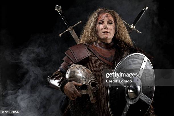 portrait of blonde viking warrior female holding a sword in studio shot - viking warrior stock pictures, royalty-free photos & images