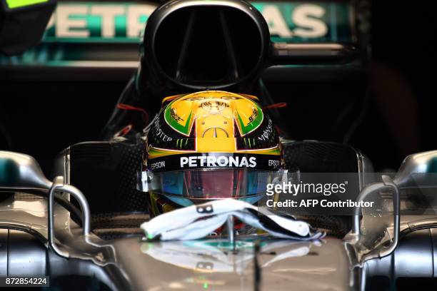 Mercedes' British driver Lewis Hamilton is pictured at the pits during the Brazilian Formula One Grand Prix third practice session at the Interlagos...