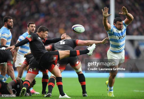 Ben Youngs of England kicks while under pressure from Agustin Creevy of Argentina during the Old Mutual Wealth Series match between England and...