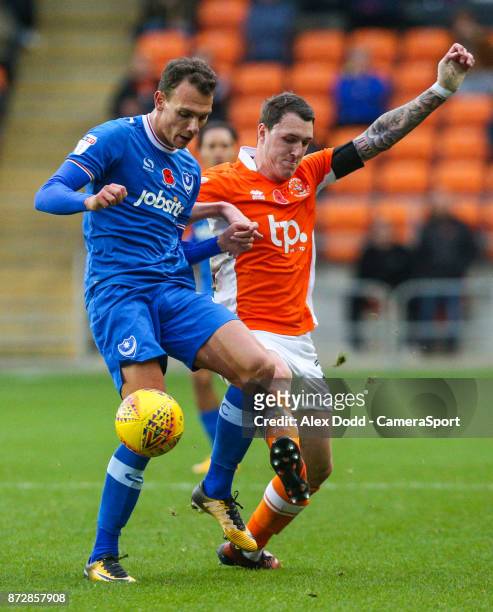 Blackpool's Callum Cooke battles with Portsmouth's Kal Naismith during the Sky Bet League One match between Blackpool and Wigan Athletic at...