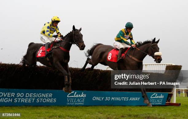 Present Man ridden by Bryony Frost lead Yala Enki ridden by Liam Treadwell over an early fence before going on to win The Badger Ales Trophy Handicap...