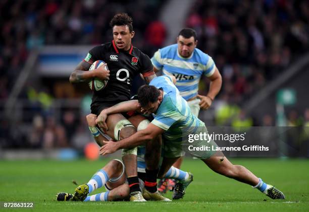 Courtney Lawes of England is tackled by Santiago Garcia Botta of Argentina during the Old Mutual Wealth Series match between England and Argentina at...