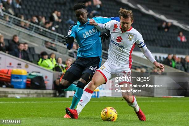 Fleetwood Town's Devante Cole competing with Milton Keynes Dons' Alex Gilbey during the Sky Bet League One match between Milton Keynes Dons and...