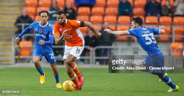 Blackpool's Curtis Tilt gets away from Portsmouth's Kyle Bennett and Ben Close during the Sky Bet League One match between Blackpool and Wigan...