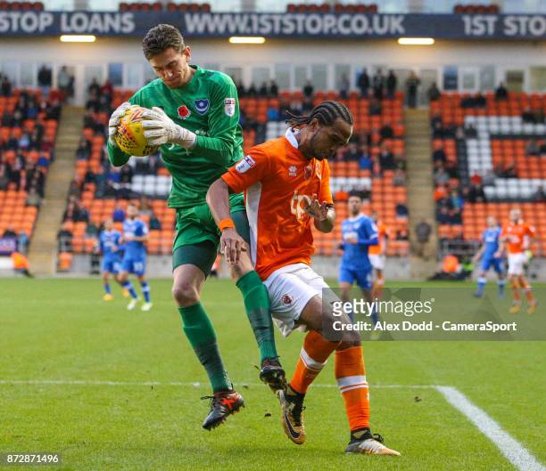 Portsmouth's Luke McGee gathers a ball ahead of Blackpool's Nathan Delfouneso during the Sky Bet League One match between Blackpool and Wigan...